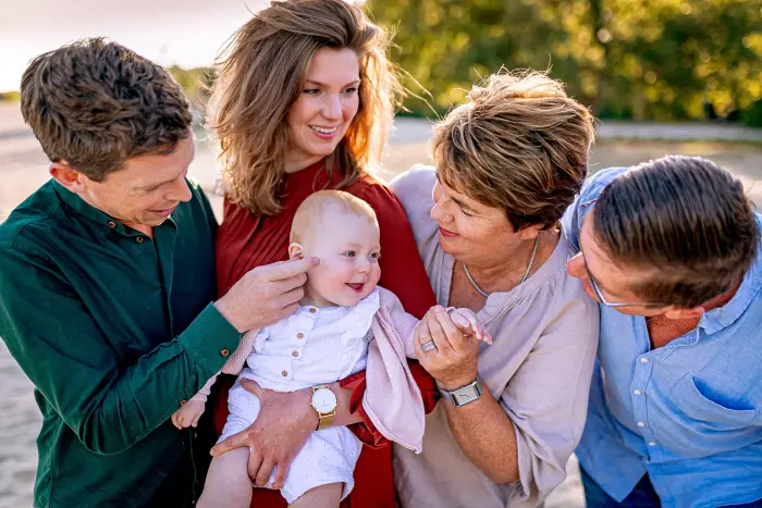 Jong gezin met opa en oma tijdens een fotoshoot in de natuur.