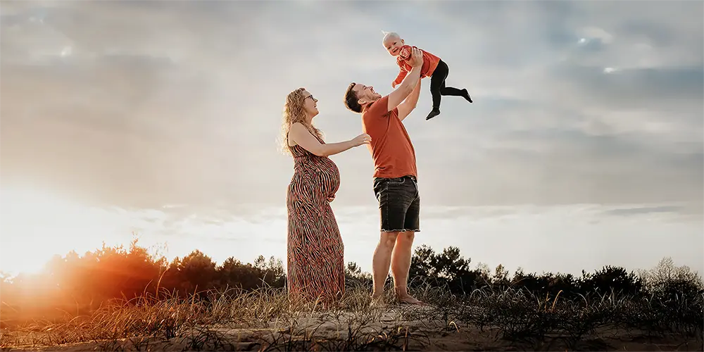 Spontane golden hour fotoshoot zwangerschapsshoot van jong gezin tijdens het gouden uur in de natuur